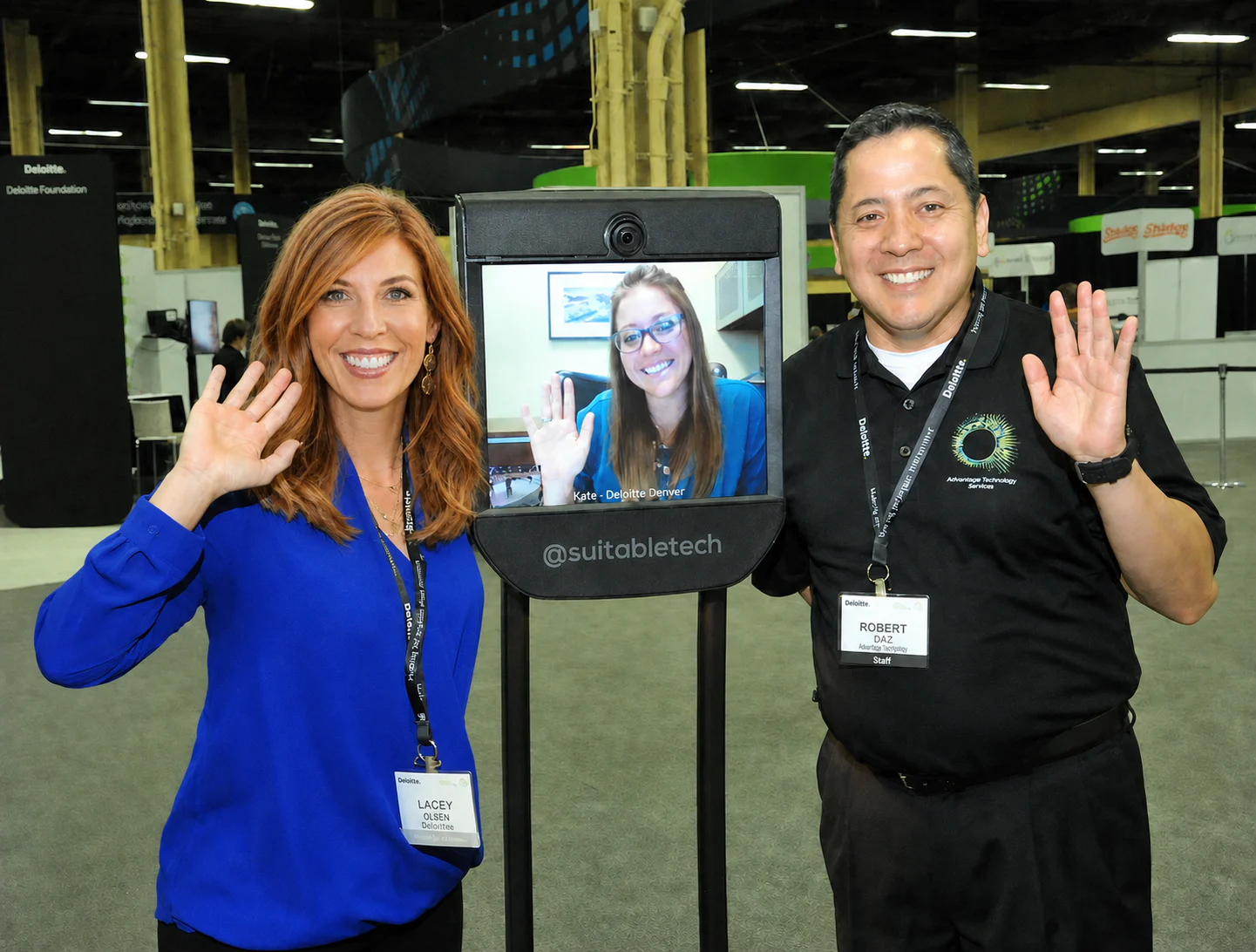 Lacey Olsen demonstrating telepresence technology with colleagues at Deloitte